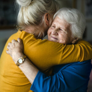 Woman hugging her elderly mother