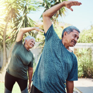 Fitness, yoga and health with a senior couple outdoor in their garden for a workout during retirement. Exercise, pilates and lifestyle with a mature man and woman training together in their backyard