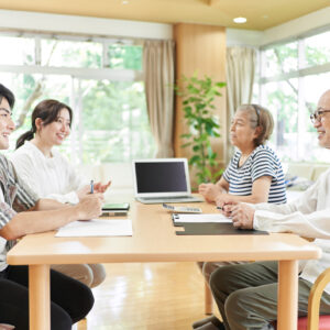 Young couple and old couple talking with a smile